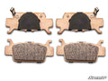 Four Honda Talon 1000 Sintered Brake Pads are arranged in two rows on a white background. The top row shows the backs with black sections and metal clips; the bottom row displays the textured friction surfaces. The SuperATV logo is visible in the corner.