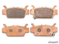 Four Honda Pioneer 1000 Sintered Brake Pads are shown, two face up showing friction surfaces and two face down revealing metal backing plates, one with a clip. The SuperATV logo appears in the bottom right corner.