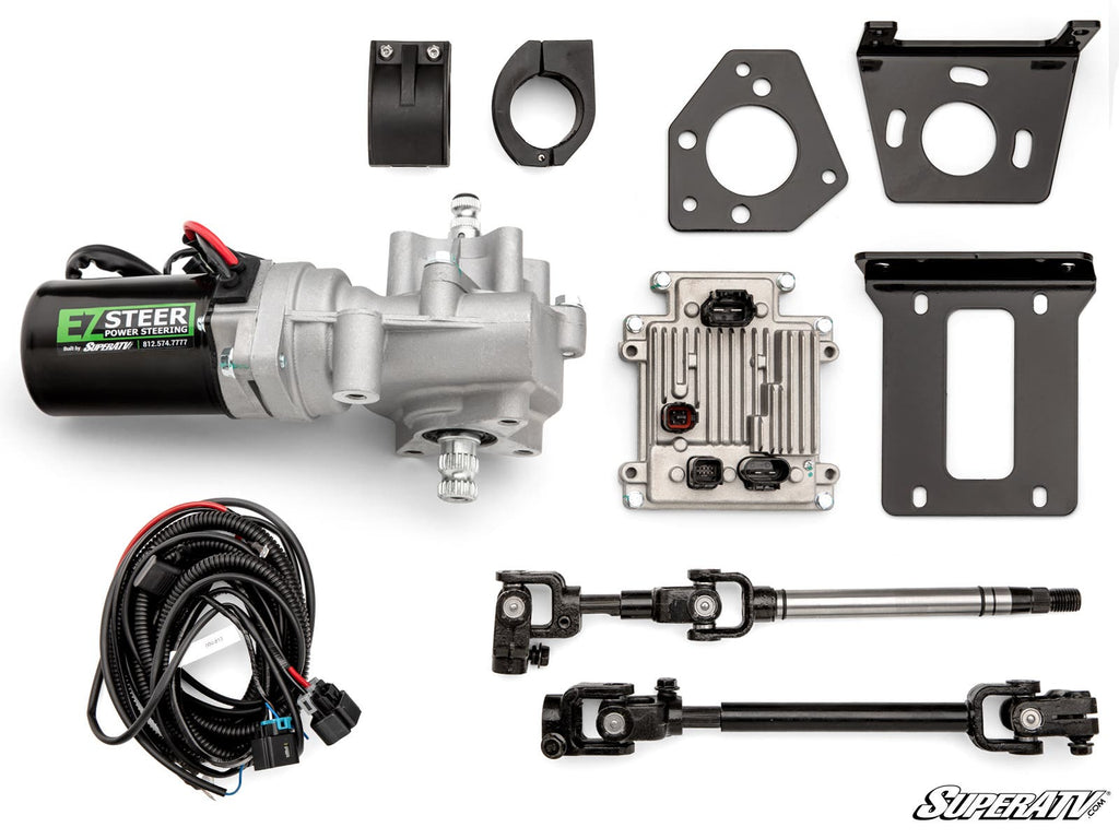 The Can-Am Maverick X3 Power Steering Kit is displayed on a white background, showing a silver electric power steering motor, wiring harness, couplers, brackets, metal shaft, black control box, connectors, and a SuperATV logo in the bottom right.
