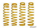 Four yellow, coiled metal springs of varying heights and tightness, from the Can-Am Commander 6 Lift Kit Replacement Springs (Set Of 4 Springs), are arranged upright in a row on a white background. The SuperATV logo appears in the bottom right corner.