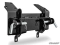 The Can-Am Commander 1000 Plow Pro Snow Plow Mount is a black metal bracket with two large cotter pins and rods, multiple bolt holes for mounting, a glossy finish, and the SuperATV logo in the bottom right corner.
