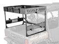 The Can-Am Defender MAX Outfitter Bed Rack, made of black metal and plastic, attaches to your UTV bed. Shown in vibrant detail on a semi-transparent vehicle, it features slotted panels and mounting holes for securing your gear.