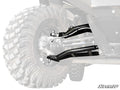 Close-up of the Can-Am Defender HD9 Atlas Pro Heim Joint 1.5 Forward Offset A-Arms, showing rugged black metal A-arms linked to a big deep-tread tire. Background fades, focusing on the suspension and SuperATV logo at the bottom right.
