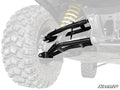 Close-up of Can-Am Defender HD10 2 Rear Offset A-Arms rear suspension with large knobby tire, black metal control arms, and bright yellow coil spring. Most of the vehicle is grayed out to highlight the A-Arms. SuperATV logo shown in lower right.