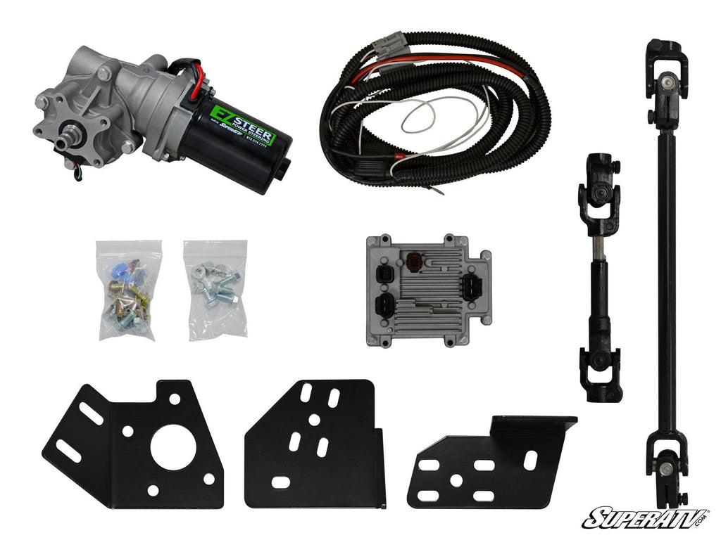 The Can-Am Maverick Power Steering Kit is displayed on a white background, featuring a motor, wiring harness, bolts in plastic bags, control module, two metal brackets, black steering shaft, and mounting plates.