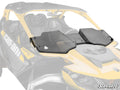 A close-up shows the Assault Industries Can-Am Maverick R Half Windshield with angular lines and folding hinges, mounted on a yellow and black Can-Am Maverick X3 side-by-side.