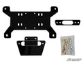 The Can-Am Maverick Winch Mounting Plate kit includes a black metal bracket with multiple holes, two smaller brackets, hardware in a clear bag (bolts, washers, nuts), and features the SuperATV logo in the bottom right corner.
