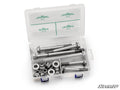 The Up & Running Can-Am Maverick Sport Suspension Bolt Kit comes in a clear plastic case with four compartments for metal bolts, washers, and nuts of different sizes. The lid features green text with part numbers, quantities, and the SuperATV logo on a wh