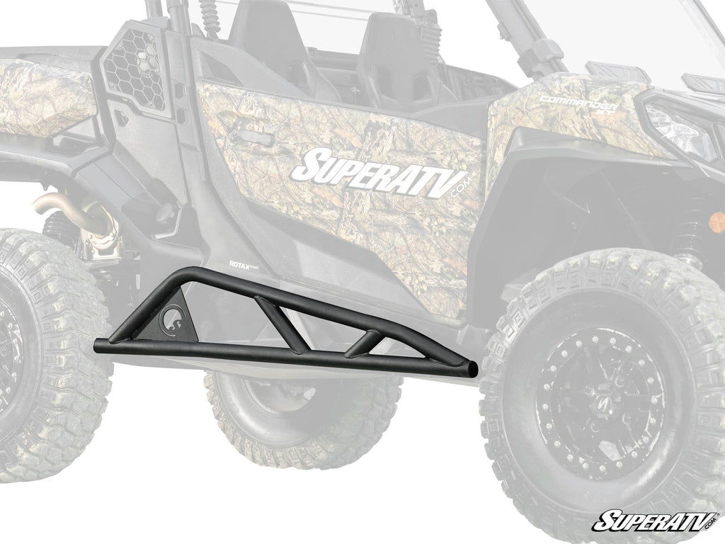 A black Can-Am Commander 1000 Tree Kicker with angular supports is shown in front of a partially faded camouflage-patterned side-by-side. The SuperATV logo in white appears at the bottom right corner of the image.