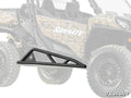 A black Can-Am Commander 1000 Tree Kicker with angular supports is shown in front of a partially faded camouflage-patterned side-by-side. The SuperATV logo in white appears at the bottom right corner of the image.