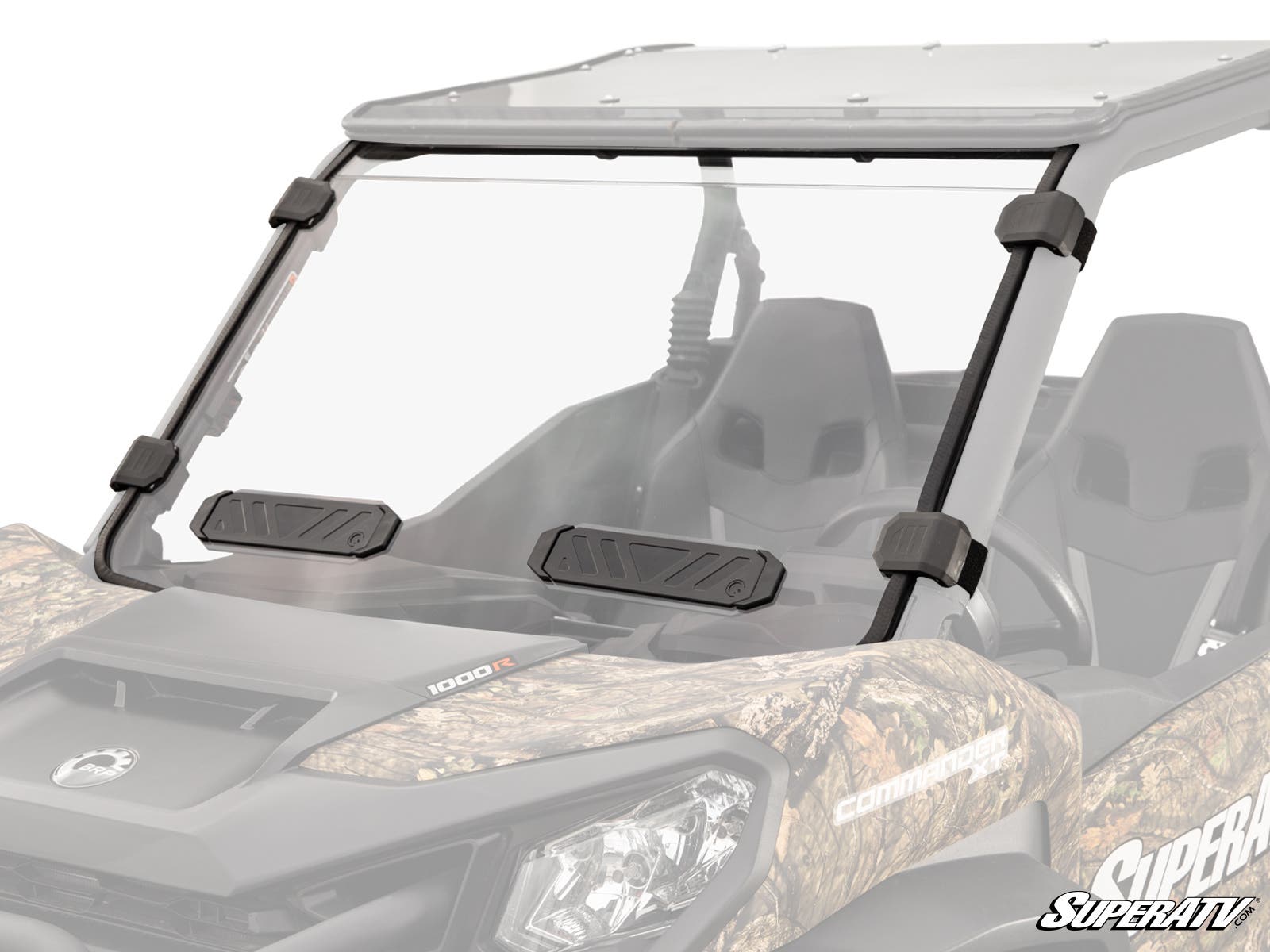 A close-up of the Can-Am Maverick Sport Vented Full Windshield shows the camouflage-patterned off-road vehicle with a clear windshield secured by four black brackets and two rectangular black vents at the bottom, set against a plain white background.