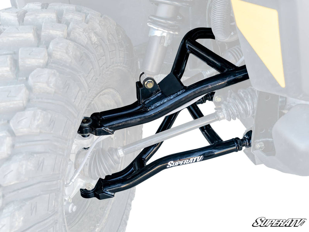 A close-up of the Can-Am Defender HD8 High-Clearance 2 Forward Offset A-Arms shows large off-road tires, black A-arms with the SuperATV logo, plus visible shocks, tie rod, and axles. The white background highlights these suspension components.