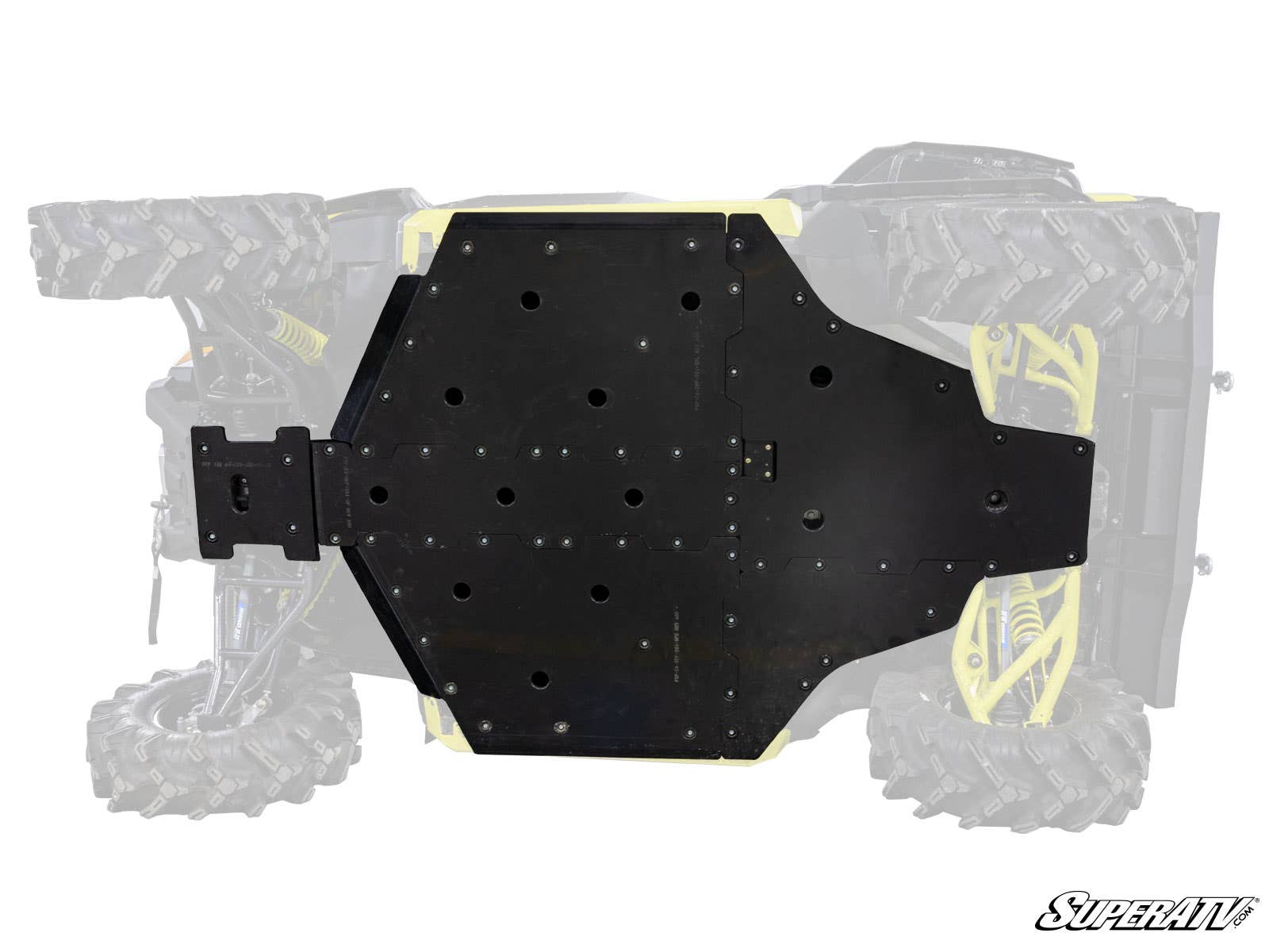 The Can-Am Defender Full Skid Plate, featuring the SuperATV logo, is a black metal plate secured with multiple screws to the underside of an off-road vehicle with large rugged tires, protecting most of the chassis.