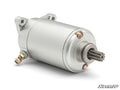 The Up & Running Can-Am Renegade Starter is a silver, cylindrical electric motor with visible mounting points, a protruding gear shaft, and secure bolts. Set against a white background, the SuperATV logo appears in the bottom right corner.