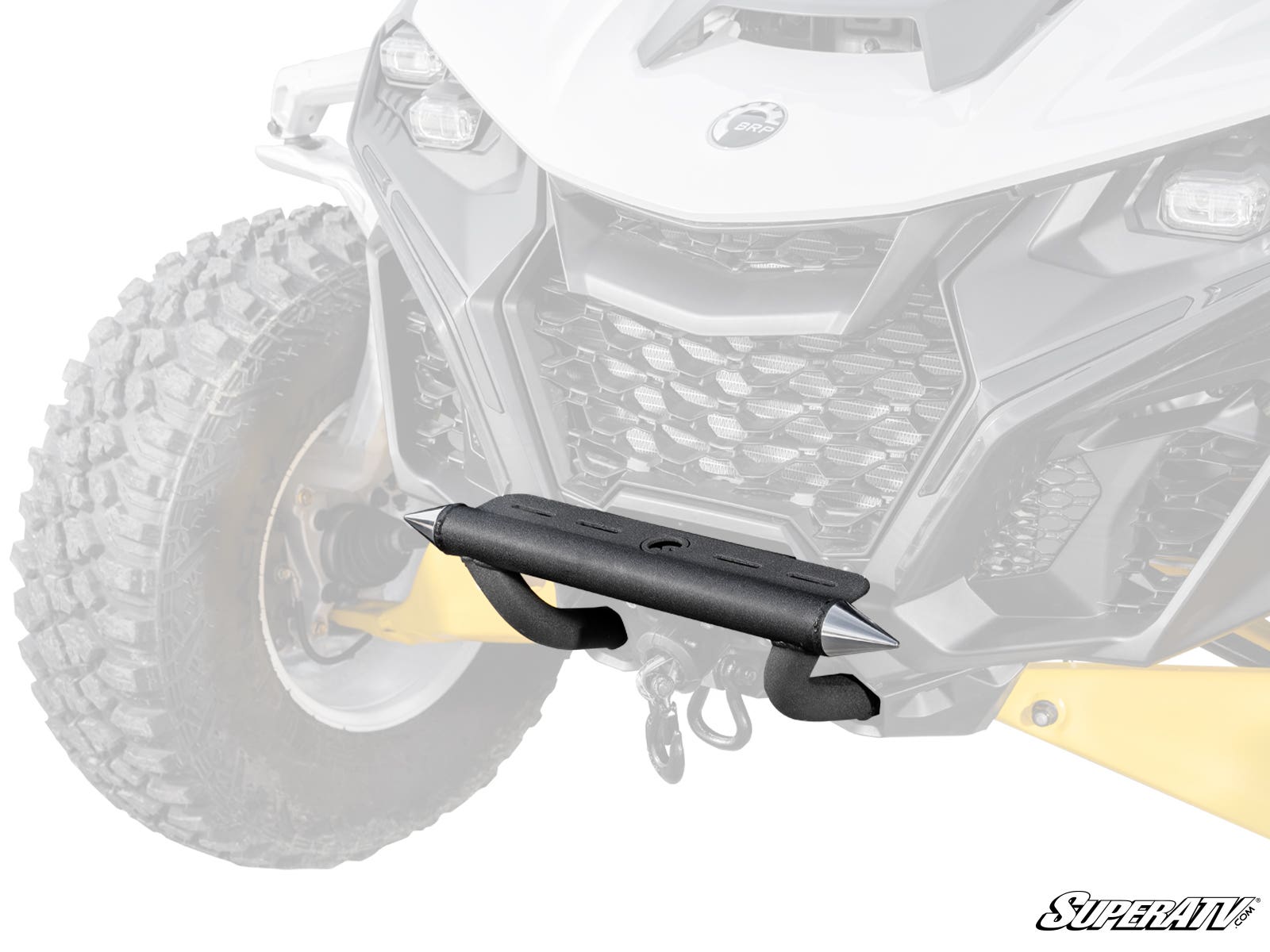 Close-up of a Can-Am Maverick R Front Bumper in black with silver end caps, mounted at the center and bottom of an ATV’s front grill. A rugged tire is visible on the left.