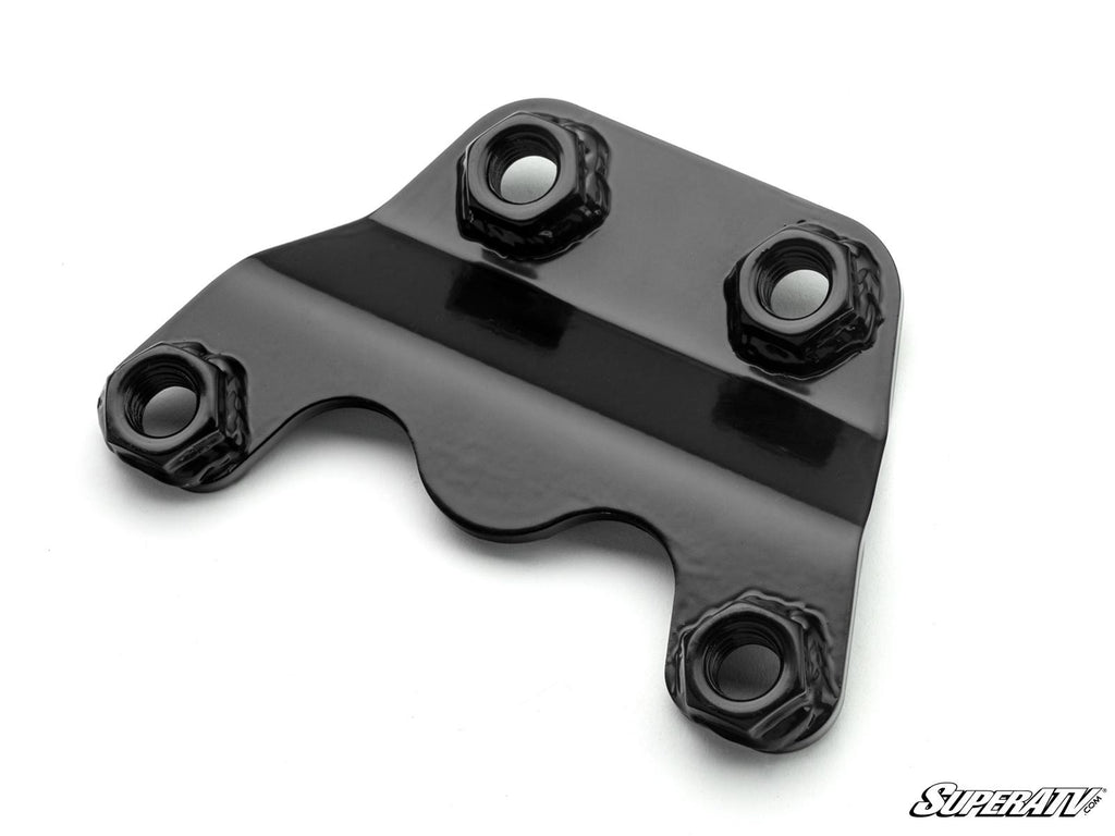 A glossy black Can-Am Maverick R Radius Arm Nut Weld Plate with four circular mounting holes—two on each corner—and smooth, reflective contours is shown against a white background. The SuperATV logo appears in the bottom right corner.