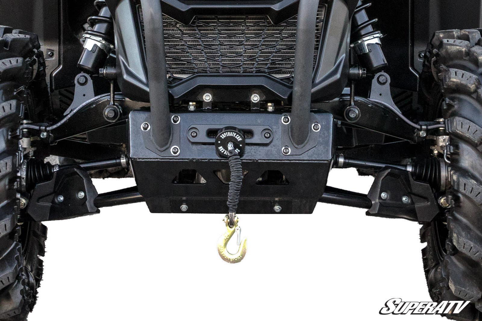 Close-up of a Can-Am Maverick Sport showing its front undercarriage equipped with a winch mounted to the Can-Am Maverick Sport Winch Mounting Plate. Rugged tires flank both sides, with the SuperATV logo in the bottom right corner.