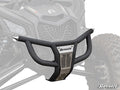 A Can-Am Maverick X3 Prerunner Front Bumper in matte black and metal, labeled SuperATV, is digitally superimposed on a rugged ATVs front, highlighting its fit and design with visible suspension, tires, and grille.