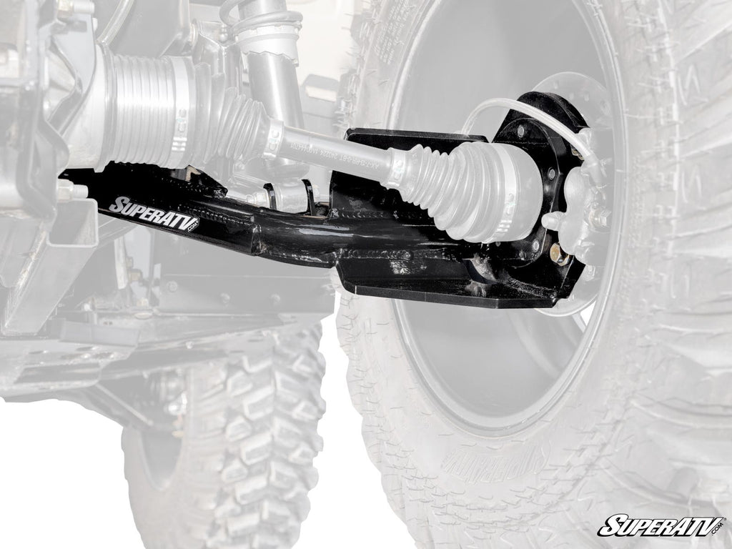 Close-up view of black Can-Am Outlander High-Clearance 2 Rear Offset Trailing Arms labeled SuperATV, attached to a UTV’s rear wheel assembly, with the wheel and suspension parts partially visible in the background, highlighting the trailing arms.