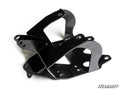 A black metal Can-Am Renegade Winch Mounting Plate with multiple holes and angled, bent surfaces is crossed on a white background. The SuperATV logo is at the bottom right. Designed for off-road vehicle suspension systems.