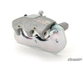 The Up & Running Can-Am Maverick Trail Brake Caliper is displayed on a white background, showing two visible pistons, bolts, and mounting hardware. The clean, angular part has the SuperATV logo in the bottom right corner.