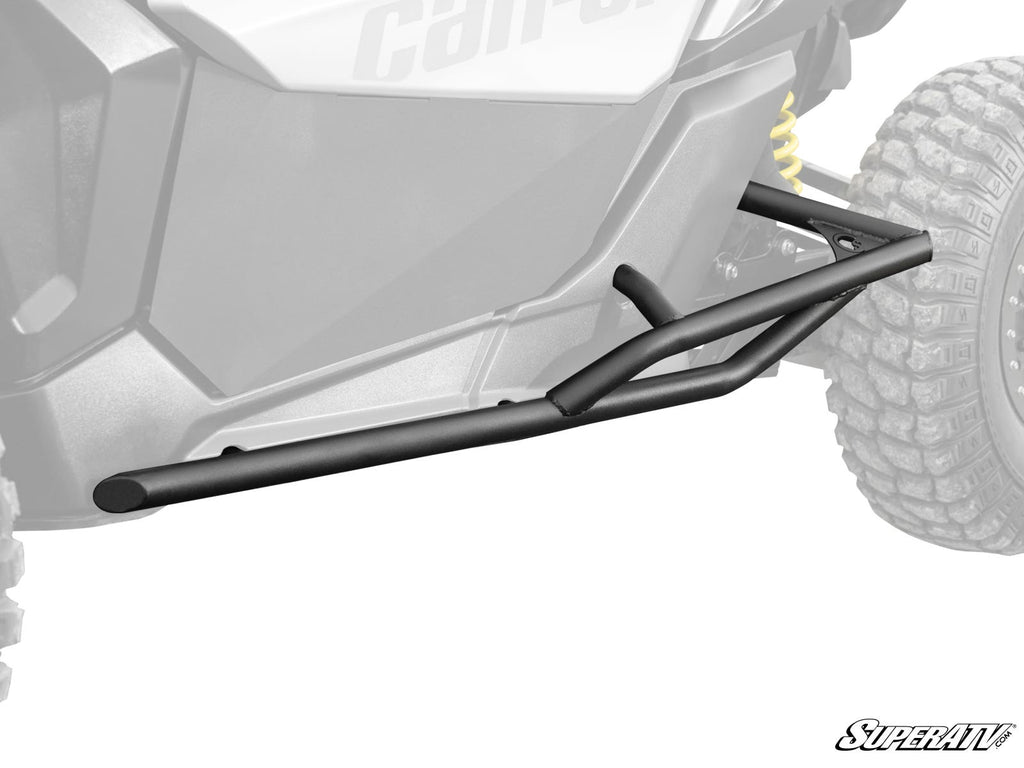 Can-Am Maverick X3 Tree Kickers are mounted along the side of an off-road vehicle, protecting the lower body and frame. The grayscale image highlights their angular, tubular design, with the SuperATV logo in the bottom right corner.