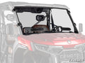 A CFMOTO UForce U10 Pro with brown seats, steering wheel, and roll bars is shown in red. It features a SuperATV logo and a vented full windshield installed with clamps and brackets.