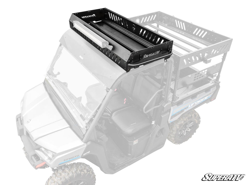 A CFMOTO UForce 1000 Outfitter Roof Rack in black metal with slotted sides and a raised edge, mounted on a gray off-road utility vehicle, holds a long LED light bar. The cab and cargo area are shown in grayscale to highlight the rack.