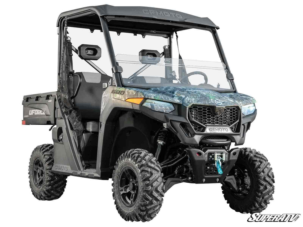 A rugged CFMOTO UForce 600 with a 2 Lift Kit and camo paint is shown from the front left, featuring big off-road tires, clear windshield, roof, side mirrors, UFORCE-branded cargo bed, and the SuperATV logo at bottom right.