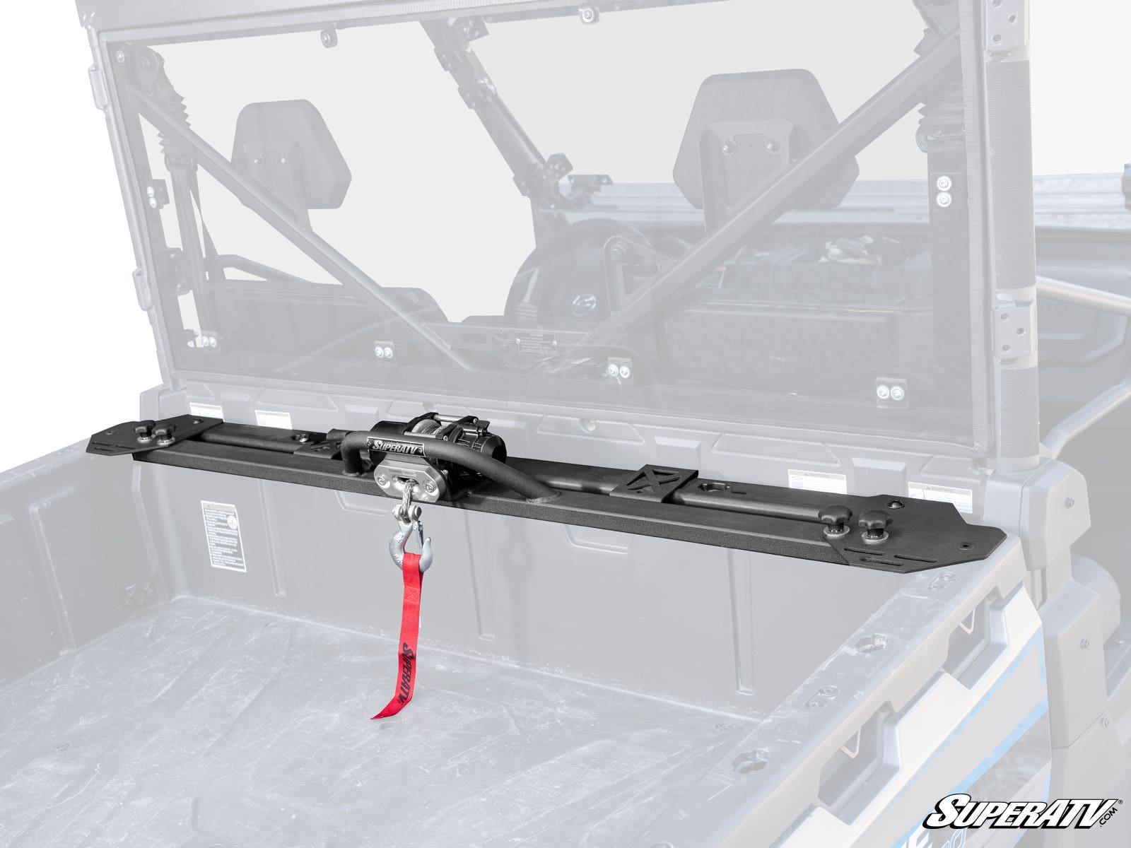 A CFMOTO UForce 1000 Bed Winch is mounted inside the black UTV cargo area, featuring a red strap on the winch hook. The UTV cab interior and roll cage are visible, with the SuperATV logo in the bottom right corner.