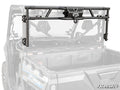 A CFMOTO UForce 1000 Game Loader Rack, shown in black metal with mounting brackets and a centered winch, is installed on a utility side-by-side. The grayscale vehicle contrasts with the rack highlighted in color. SuperATV logo appears bottom right.