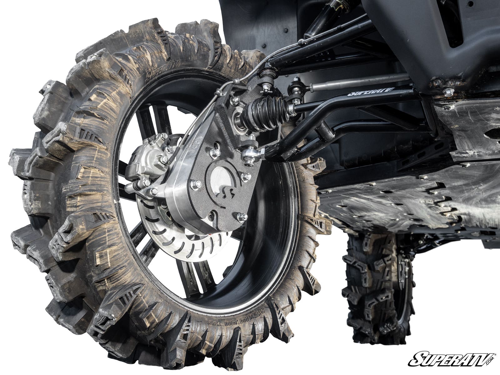 Close-up of a rugged ATV tire with deep treads on a heavy-duty black rim, showing suspension and brake components of a CFMOTO UForce 1000 with 8 Portal Gear Lift. The SuperATV logo appears in the lower right corner.