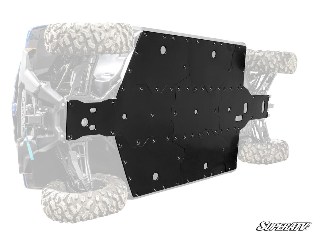 A rugged black CFMOTO UForce 1000 XL Full Skid Plate is mounted beneath an off-road vehicle with large, knobby tires. The faded background highlights the plate’s size, bolt pattern, and coverage, with the “SuperATV” logo at lower right.