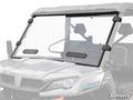 A close-up of a CFMOTO UForce 1000 Vented Full Windshield shows its full, clear panel with a black frame, two black bottom vent panels, and secure four-clamp attachment. The SuperATV logo appears in the lower right corner.