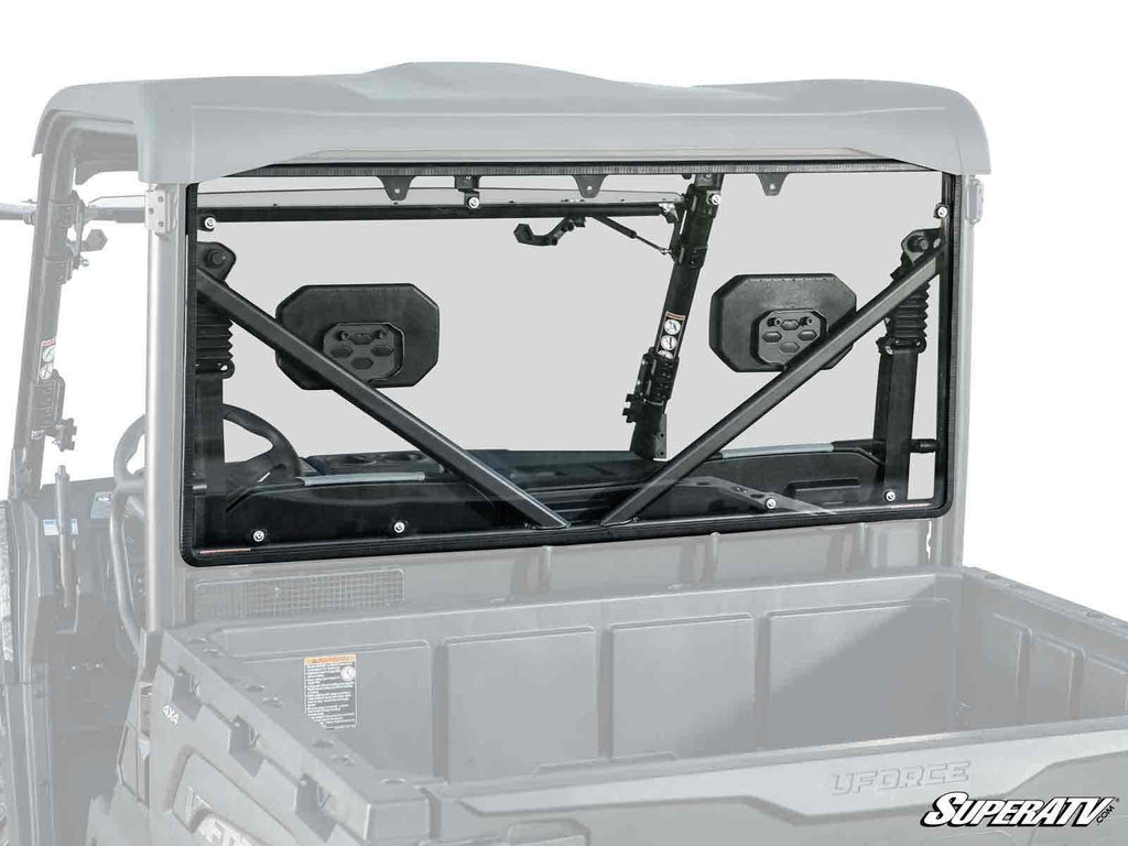 A CFMOTO UForce 600 with a rear windshield installed, featuring two black side mirrors, X-shaped support bars, and an empty cargo bed. The SuperATV logo is visible in the lower right corner of the windshield.