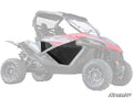 The image features CFMOTO ZForce Aluminum Lower Doors installed on a red and black side-by-side. The rugged off-road vehicle has a roll cage, roof, chunky tires, and displays the “SuperATV” logo in the bottom right corner.