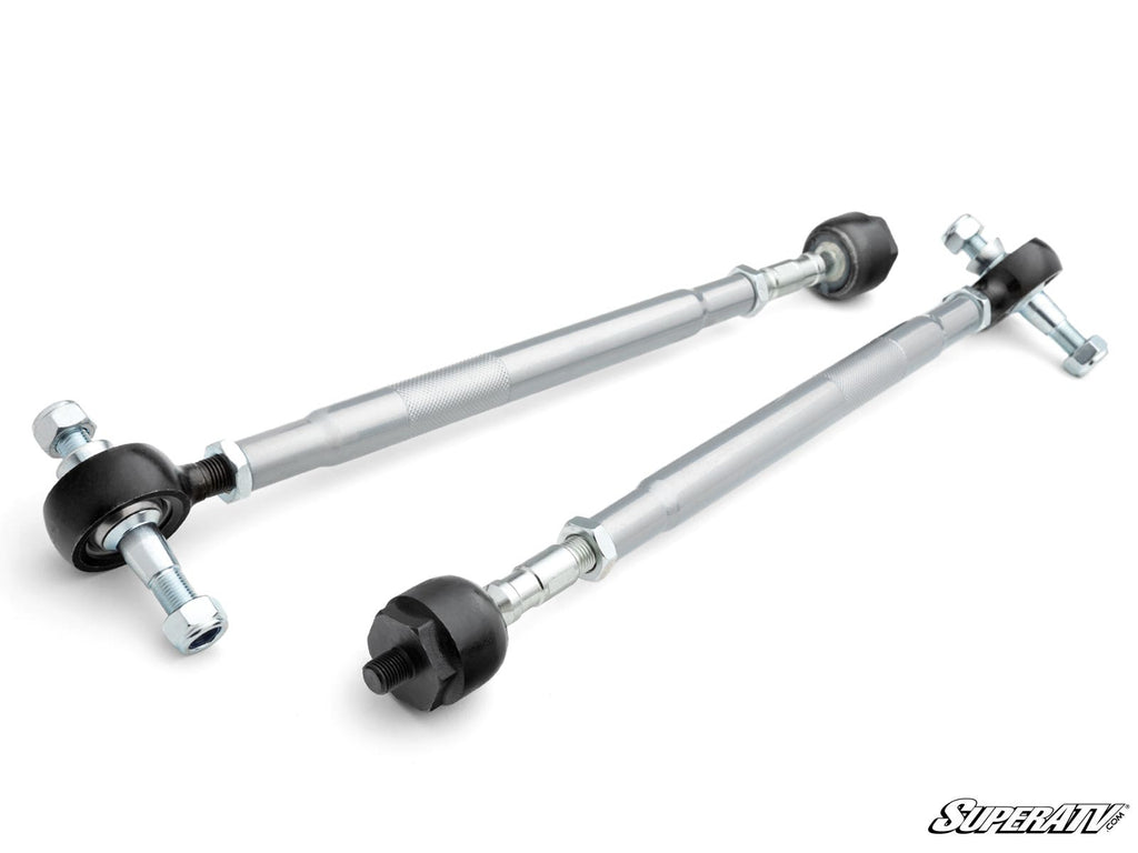 Two CFMOTO ZForce 950 Sport Swaged Tie Rods with black rubber ends and silver hardware are displayed diagonally on a white background. The rods feature sturdy threaded sections, adjusting nuts, and a “SuperATV” logo in the lower right corner.