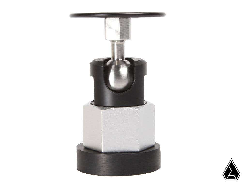 The Assault Industries Magnetic Swivel Mount features a precision-engineered hexagonal silver base, black circular bottom, central sphere connecting the parts, a rotating black handle on top, and a white background with a small black geometric logo bottom