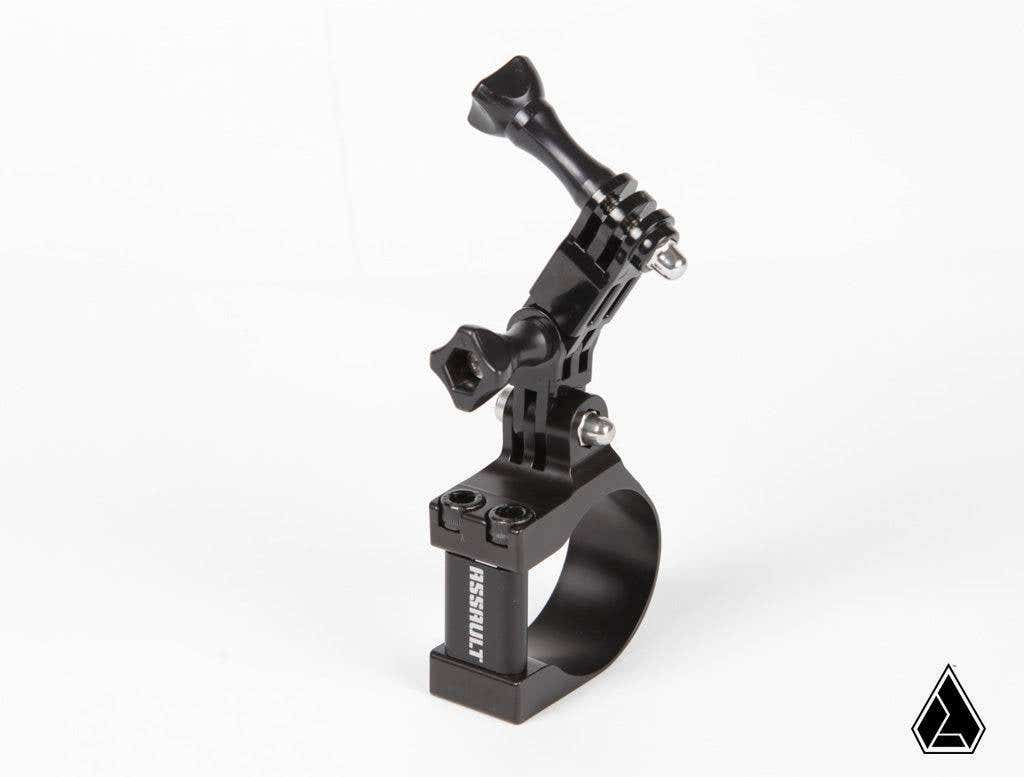 The Assault Industries Rugged Action Camera Mount Clamp is a black metal mount with adjustable knob-secured joints, GoPro-style top connector, SESSION branding, and a small black triangle logo in the white background corner. Designed for handlebars or tub
