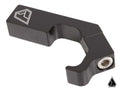 A black, angular metal Assault Industries M10 Pro-Fit Cage Clamp for Polaris and Can Am cages, featuring a geometric logo engraving on one end, a hex bolt on the other, and a curved inner section for mounting. A small logo appears bottom right.