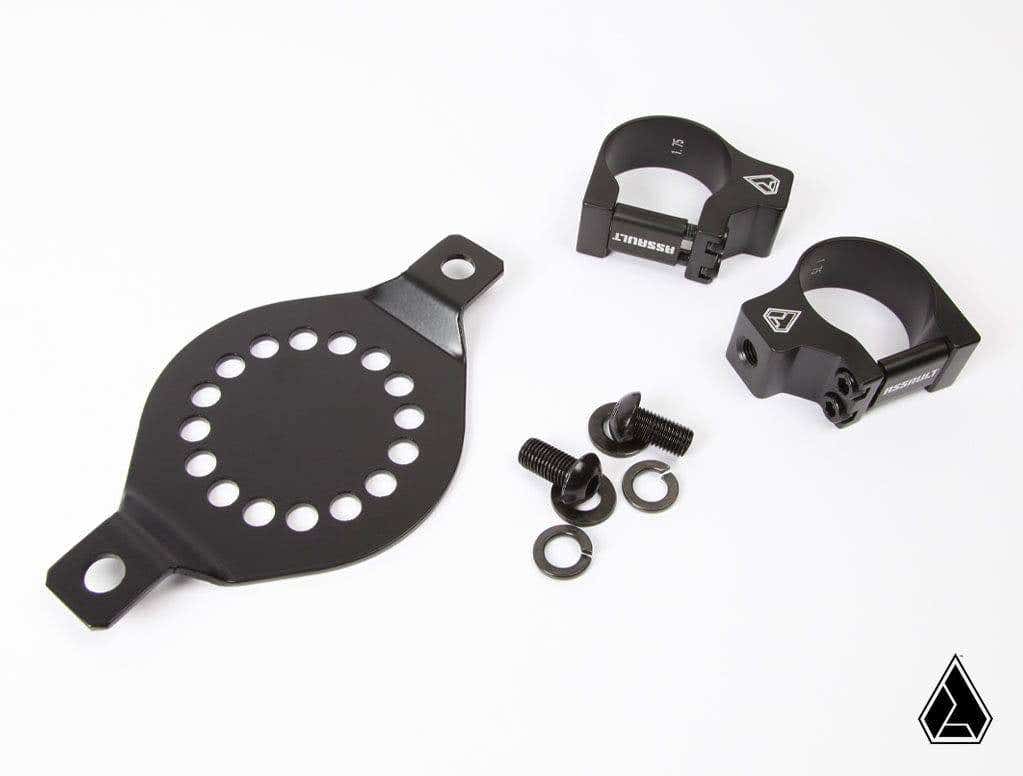 The Assault Industries Rotopax Mount For Water/First Aid includes a black metal kit with a round perforated plate, two clamp brackets with logos, two screws, and two washers, all shown neatly arranged on a white background.