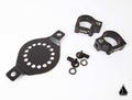 The Assault Industries Rotopax Mount For Water/First Aid includes a black metal kit with a round perforated plate, two clamp brackets with logos, two screws, and two washers, all shown neatly arranged on a white background.