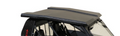 A close-up of the Can-Am Commander Armor Tech Roof, shown in black with a textured finish, angular lines, and a slightly raised center. The roof covers the side-by-side’s passenger area against a white background with some sand visible.