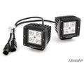Two black, square Polaris Ranger Rear-Facing LED Cube Lights feature ridged housing and four LEDs each, connected by black cords with dual plug connectors. The SuperATV brand is printed on the lights; background is plain white.