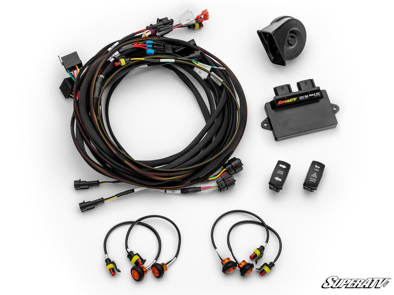 The Can-Am Commander Self-Canceling Turn Signal Kit includes a wire bundle with connectors, electronic control module, small black horn, two rocker switches, and four round sensors—arranged on a white background with the SuperATV logo in the corner.