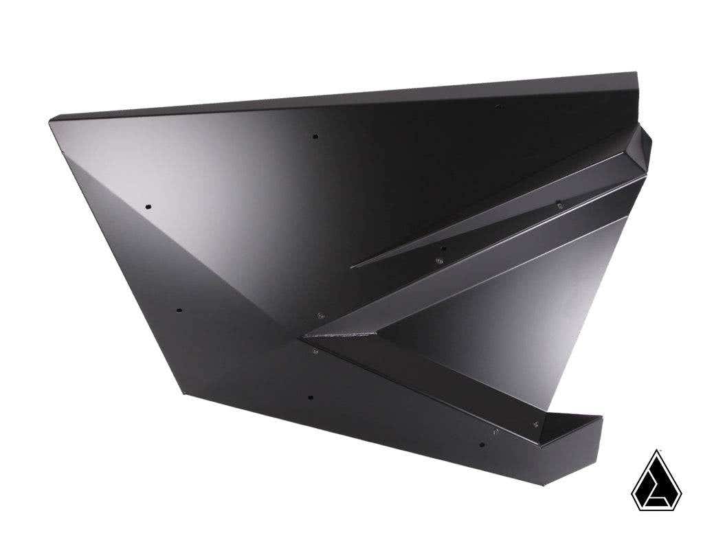 The Assault Industries Stinger Doors for Polaris RZR Pro XP and Pro R feature a geometric, angular black metal design with sharp edges and flat surfaces, forming an abstract 3D shape against a white background. A small black triangle icon is at the lower 