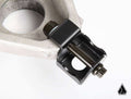 Close-up of the Assault Industries Radius Rod Double Shear Bracket Kit for Can Am Maverick X3, featuring a large circular opening on one end and a black jointed connector with a bolt, displayed on a white background with logo in the corner.