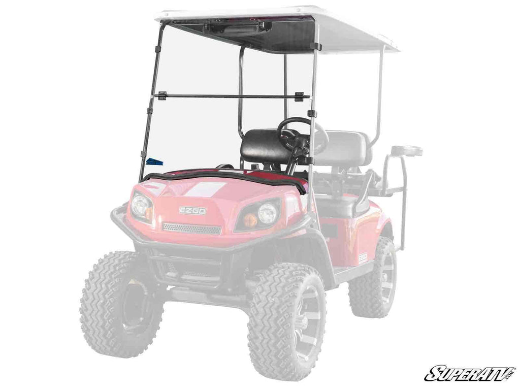 A Corsa Blue E-Z-GO Express S with a flip down windshield is shown from the front at an angle. The tinted windshield is in focus, while the rest of the cart and background are faded. The “SuperATV” logo appears in the bottom right corner.