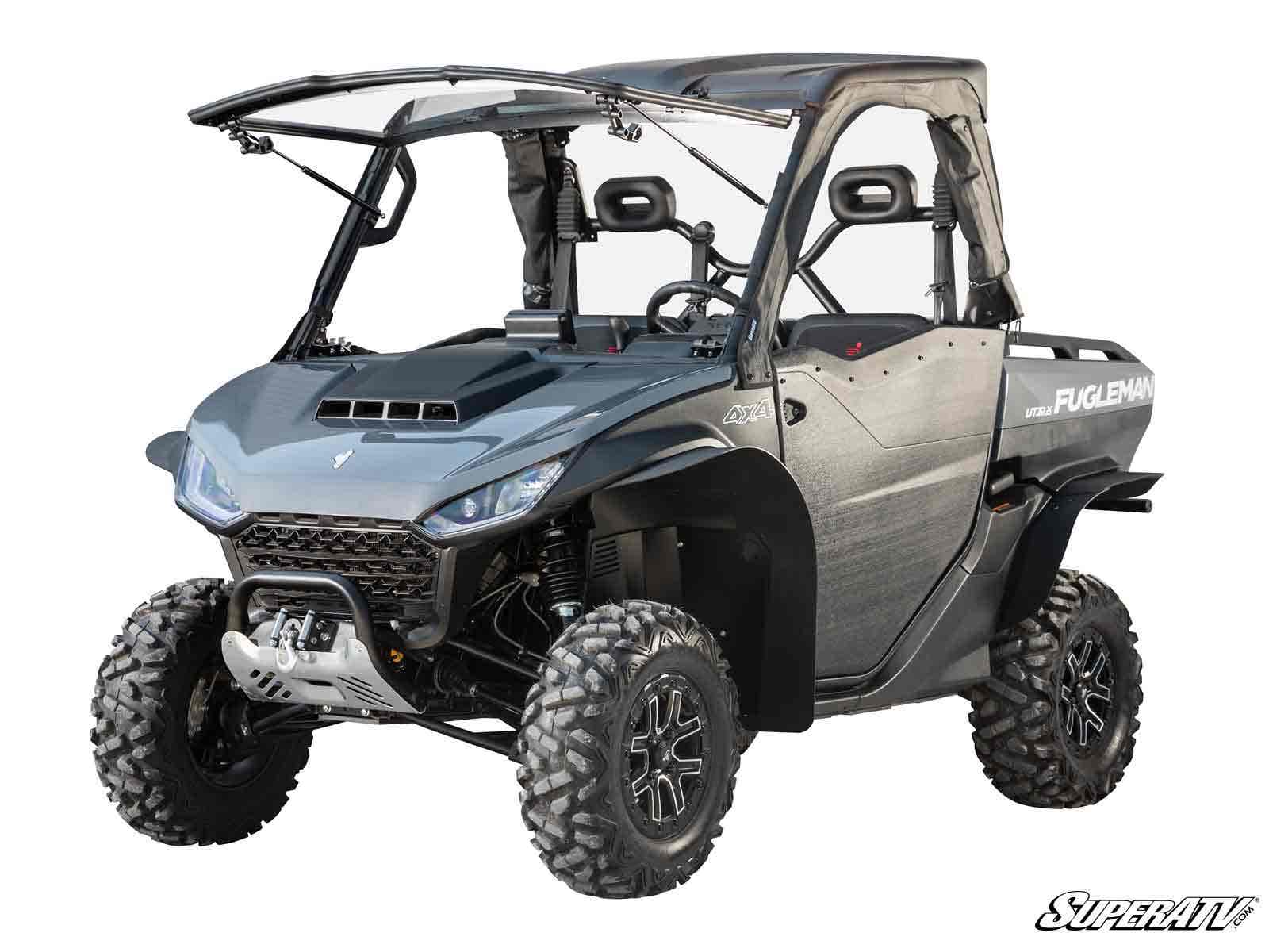 The Segway Fugleman UT10 2 Lift Kit is shown installed on a gray off-road utility vehicle with a roof, rugged tires, side doors, front winch, black grill, and Fugleman branding—built for rough terrain and outdoor use.