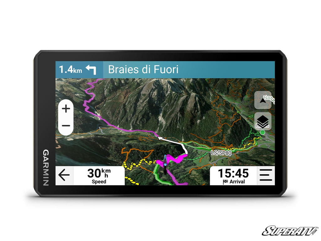 The Garmin Tread 26 Powersport Navigator shows a detailed topo map with colorful trails, blue route line, 30 km/h speed, arrival time of 15:45, terrain and elevation info. Braies di Fuori is displayed as the destination 1.4 km ahead.